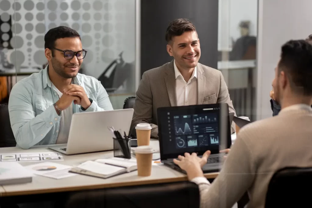 Enterprise AI adoption workshop with advisors reviewing an analytics dashboard